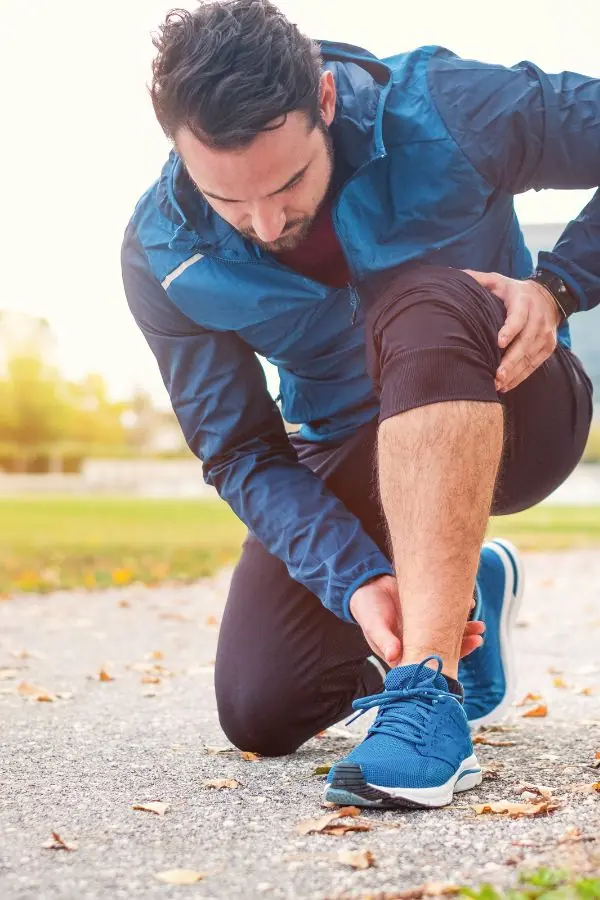 Jogger clutching their ankle