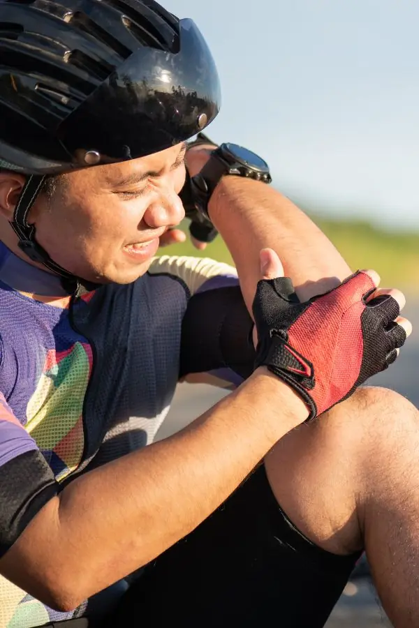 Biker clutching their elbow