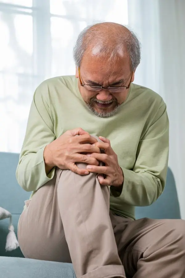 Person clutching their knee