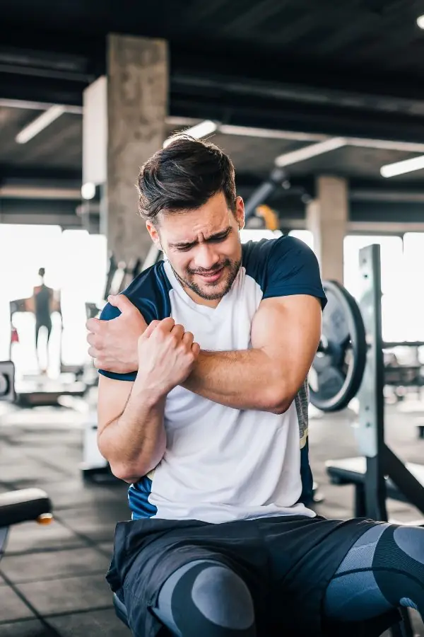 Weight lifter clutching their shoulder