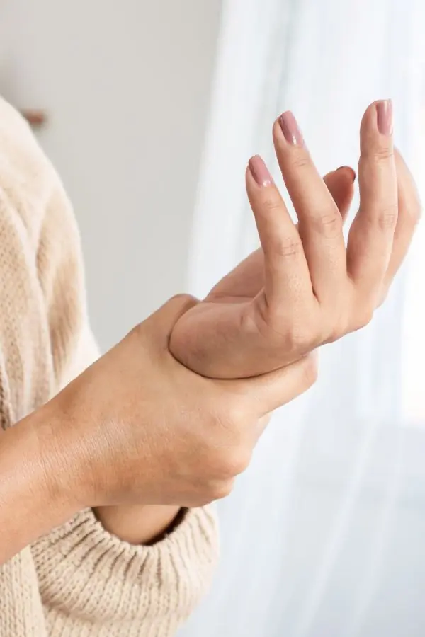 Person clutching their inflamed wrist